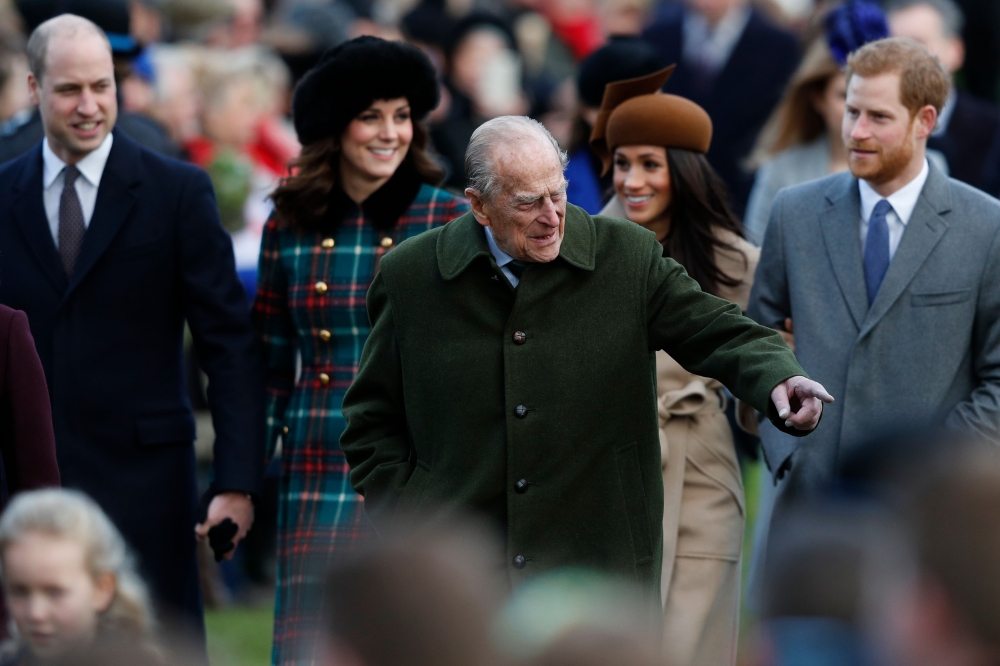Britain's Prince Philip, Duke of Edinburgh, center, gestures as he is followed by, from left, Britain's Prince William, Duke of Cambridge, Britain's Catherine, Duchess of Cambridge, US actress and finacee of Britain's Prince Harry Meghan Markle and Britain's Prince Harry arriving to attend the Royal Family's traditional Christmas Day church service at St Mary Magdalene Church in Sandringham, Norfolk, eastern England, on Monday. - AFP