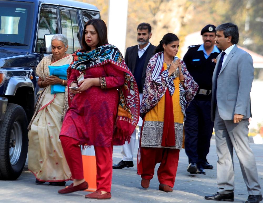 Former Indian navy officer Kulbhushan Sudhir Jadhav’s mother Avanti, left, and wife, Chetankul, third right, arrive to meet him at Ministry of Foreign Affairs in Islamabad, Pakistan, on Monday. — Reuters