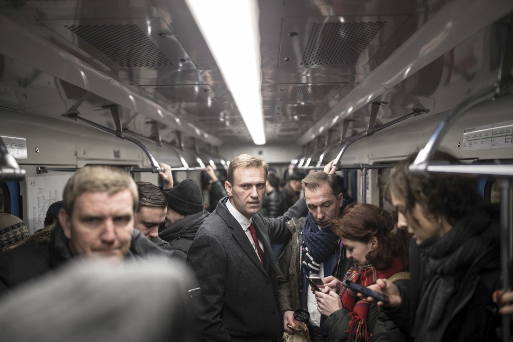 Russian opposition leader Alexei Navalny, who submitted endorsement papers necessary for his registration as a presidential candidate, center, rides subway to attend a meeting in the Russia’s Central Election commission in Moscow, Russia, on Monday. — AP