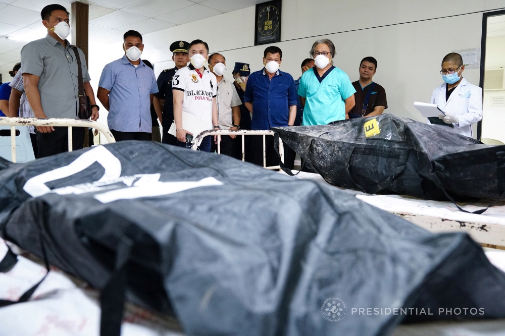 Philippines’ President Rodrigo Duterte visits the remains of the victims, who died in the recent fire incident at the New City Commercial Center (NCCC) mall, at the Southern Philippines Medical Center (SPMC) in Davao city, southern Philippines, on Monday. — Reuters