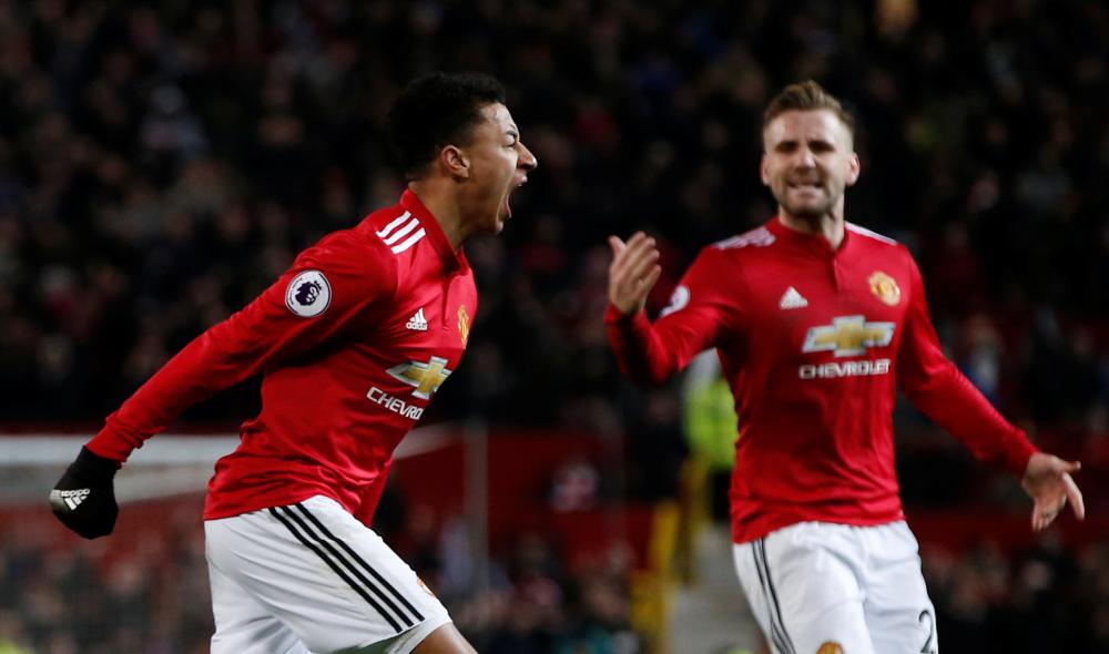 Manchester United's Jesse Lingard celebrates scoring their second goal with Luke Shaw during their Premier League match against against Burnley at Old Trafford Tuesday. — Reuters