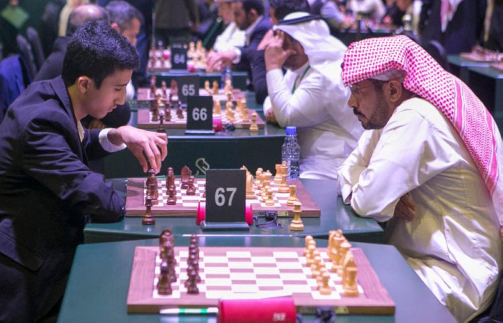 Norwegian chess player Magnus Carlsen (R) attends the King Salman World Rapid and Blitz Championships, the first international chess competition held in Saudi Arabia. — AFP