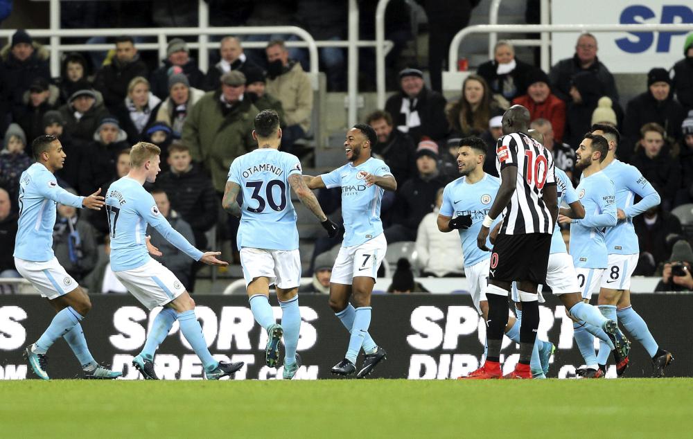 Manchester City’s Raheem Sterling (C) celebrates with teammates after scoring his side’s first goal of the game during their English Premier League soccer match against Newcastle United at St James’ Park, Newcastle, Wednesday. — AP