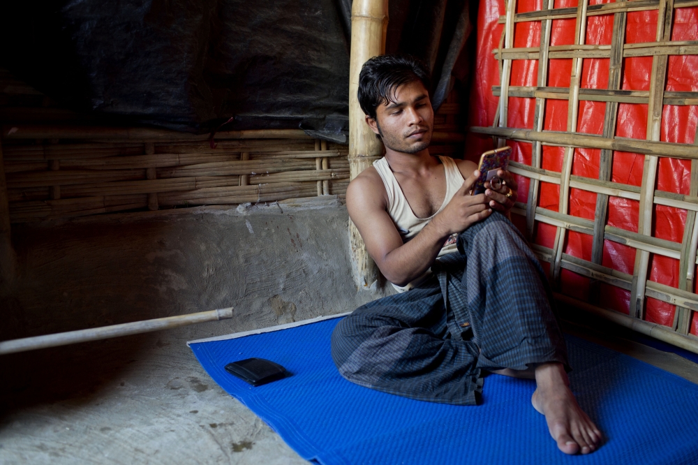 Mujibullah, 22, a Rohingya refugee watches a video, which he has shot in Myanmar before crossing over into Bangladesh, at Kutupalong refugee camp in Ukhiya, Bangladesh, in this Dec. 23, 2017 file photo photo. — AP