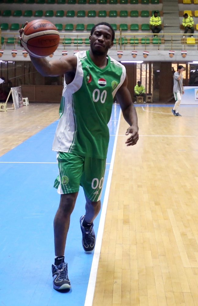 Baghdad’s Oil Club guard DeMario Mayfield, center, watches a free-throw during a basketball match against Iraq's Airline Club in Baghdad in this Dec. 7, 2017 file photo. — AFP