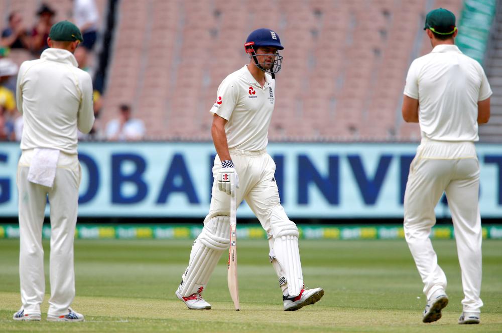 Australian players congratulate England’s Alastair Cook as he walks off the ground at the end of England’s first innings during the fourth day of the fourth Ashes cricket Test match at MCG Friday. — Reuters