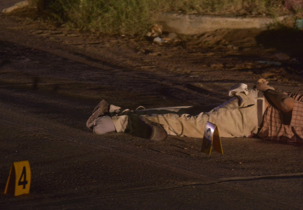 The bodies of two men killed with a point-blank shot to the head, who were taken to the forensic service as unidentified victims, lie on the ground in the Nopalitos neighborhood on the outskirts of Acapulco, Guerrero state, in this Nov 25, 2017 file photo. — AFP