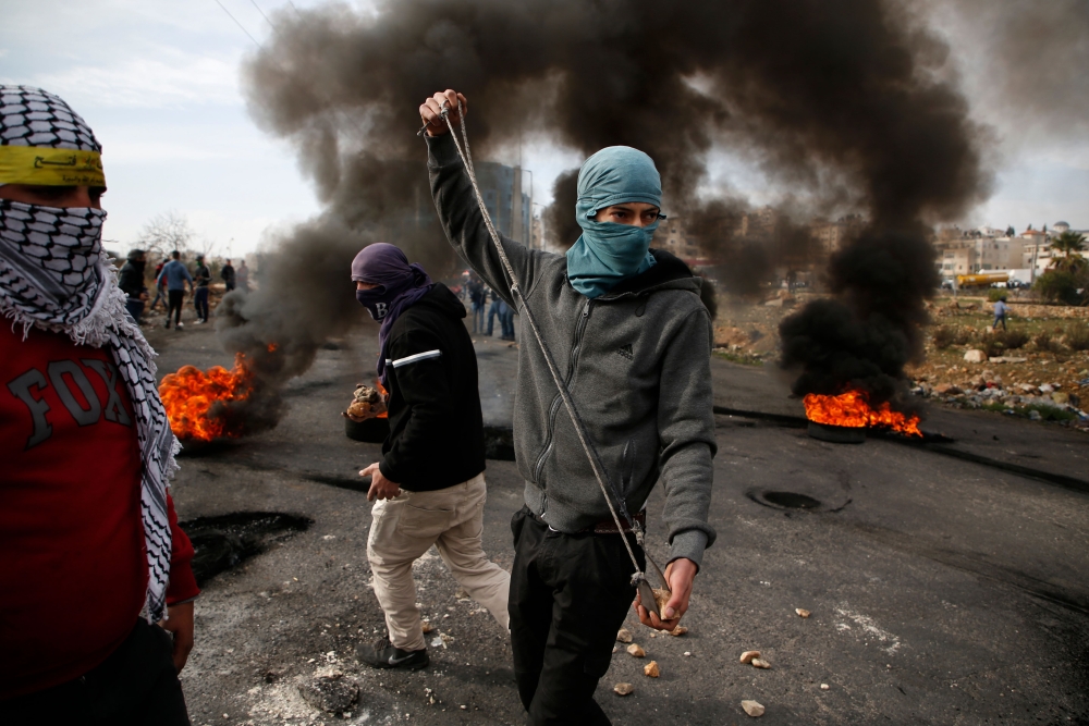 Palestinian protestors clash with Israeli security forces following the Friday prayers in the West Bank city of Ramallah. — AFP