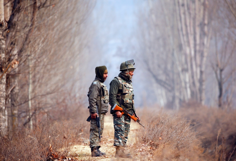 Policemen stand guard outside the Central Reserve Police Force (CRPF) training center during a gun battle with suspected militants in Lethpora in south Kashmir’s Pulwama district on Sunday. — Reuters