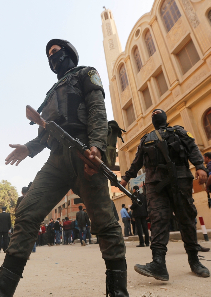 Security forces stand guard at the site of attack on Mar Mina church in Helwan district on the outskirts of Cairo, Egypt. — Reuters