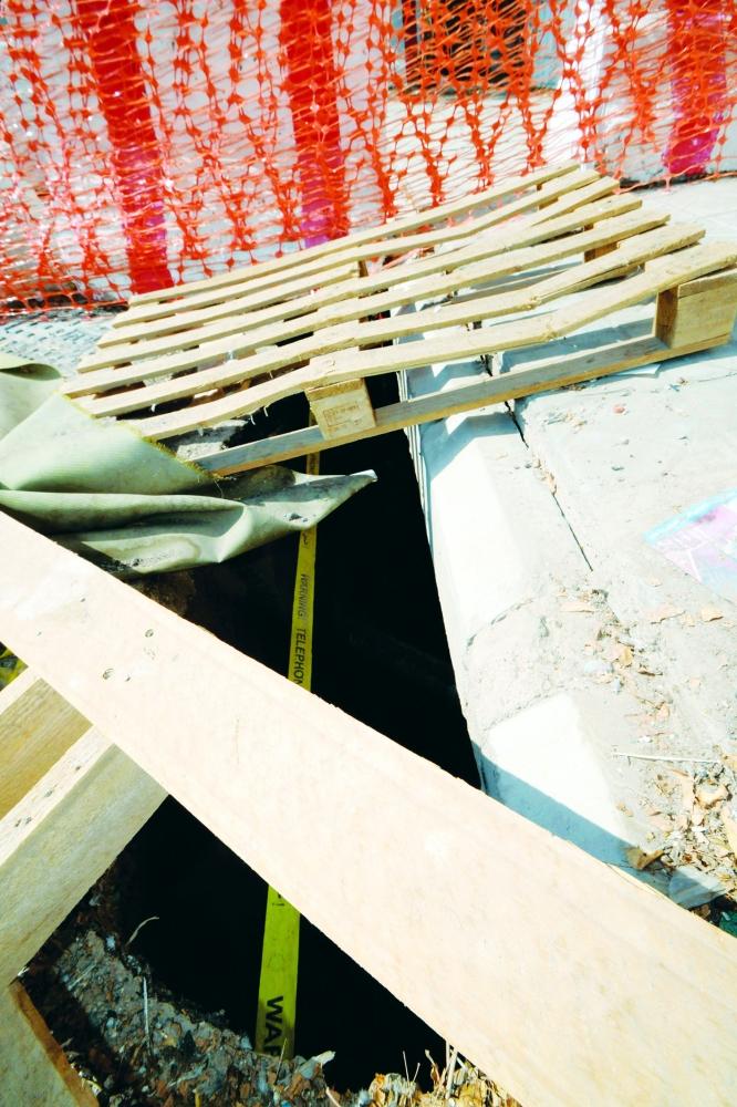 Barricades placed on the hole to protect people from falling into it. — Courtesy Al-Madina