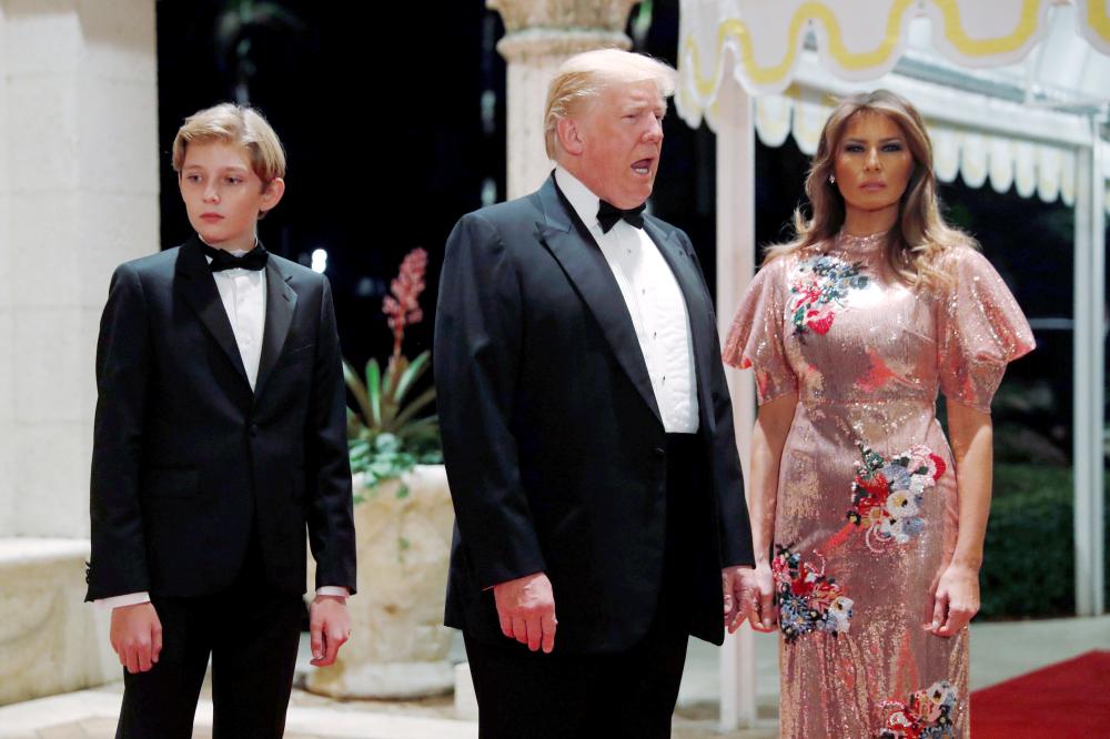 US President Donald Trump and first lady Melania Trump, with their son Barron, arrive for a New Year’s Eve party at his Mar-a-Lago club in Palm Beach, Florida, on Sunday. — Reuters