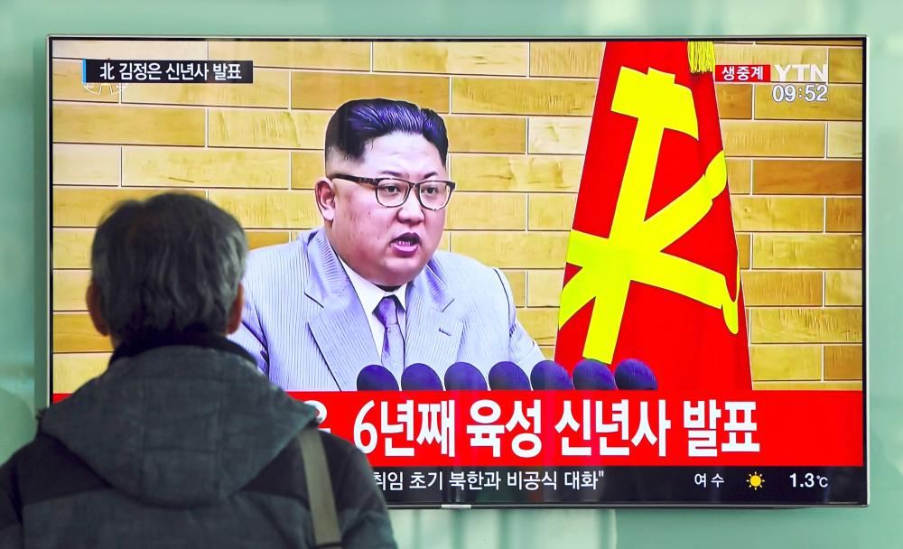 A man watches a television news broadcast showing North Korean leader Kim Jong-Un’s New Year’s speech, at a railway station in Seoul on Monday. — AFP