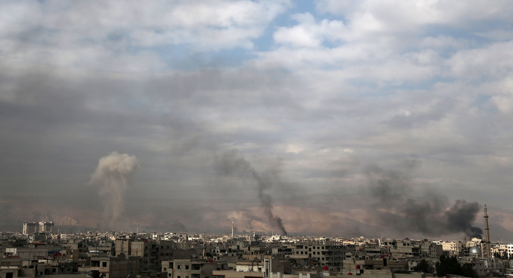 Smoke billows following a reported air strike on the rebel-held besieged town of Arbin, in the eastern Ghouta region on the outskirts of the capital Damascus. — AFP