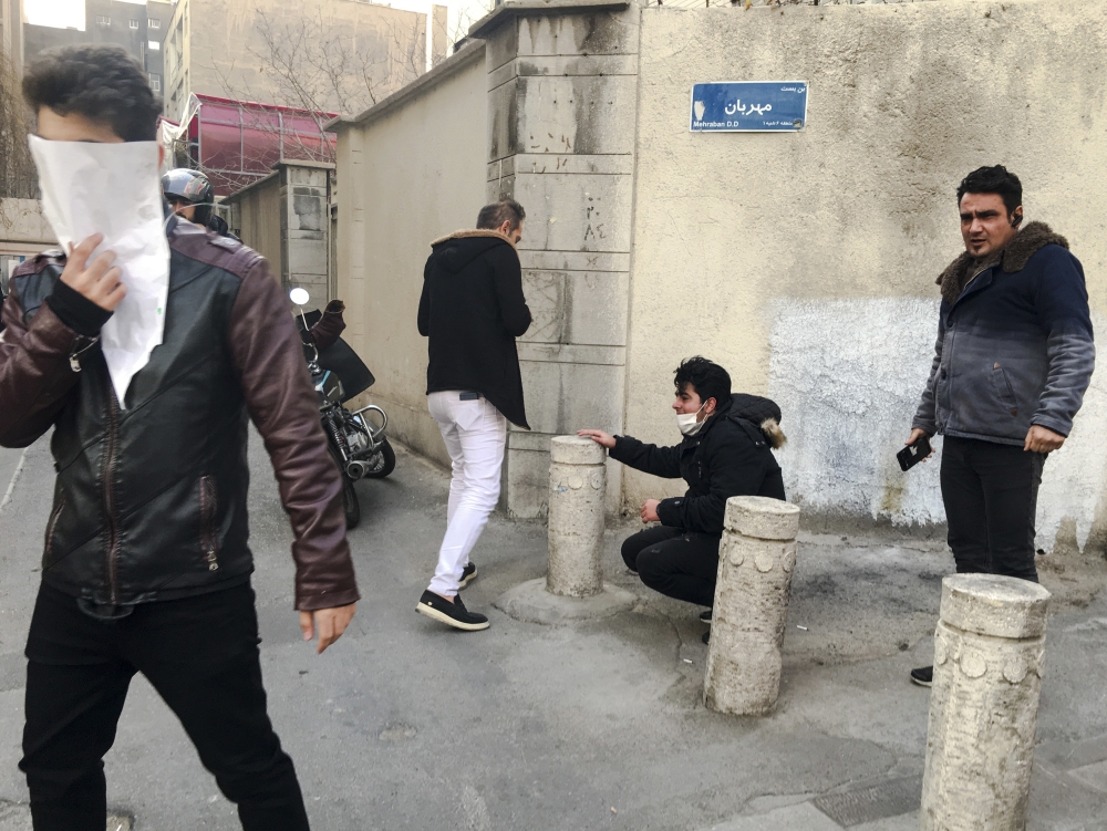 University students attend a protest inside Tehran University while anti-riot Iranian police prevent them to join other protesters, in Tehran. — AP