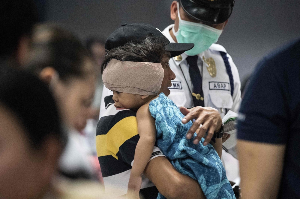 A child injured by firecracker is seen at the Jose Reyes Memorial Medical Center in Manila early on Monday, after New Year’s celebrations. — AFP
