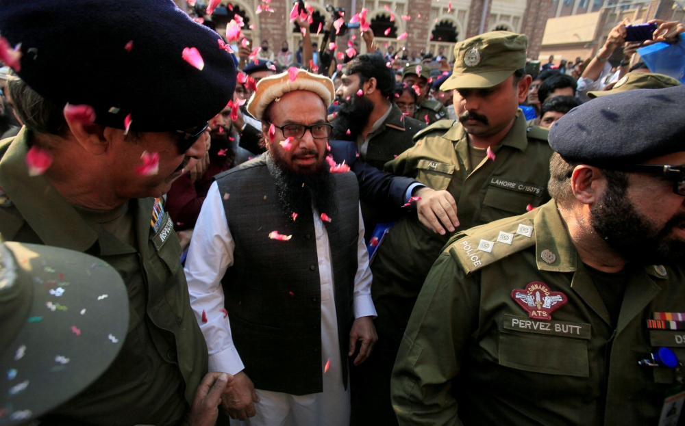 Hafiz Saeed is showered with flower petals as he walks to court before a Pakistani court ordered his release from house arrest in Lahore, Pakistan, in this Nov. 22, 2017 file photo. — Reuters