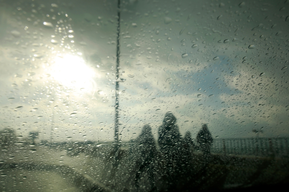 A picture taken from inside a car shows Palestinians walking along the Gaza City coastline. — AFP