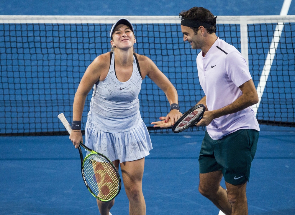 A Tuesday photo of Belinda Bencic, left, and Roger Federer of Switzerland showing them applauding during their mixed doubles match against Karen Khachanov and Anastasia Pavlyuchenkova of Russia at the Hopman Cup tennis tournament in Perth, Australia. Federer and Bencic advanced Switzerland into the Hopman Cup final with straight-set singles victories over their American opponents. — AP