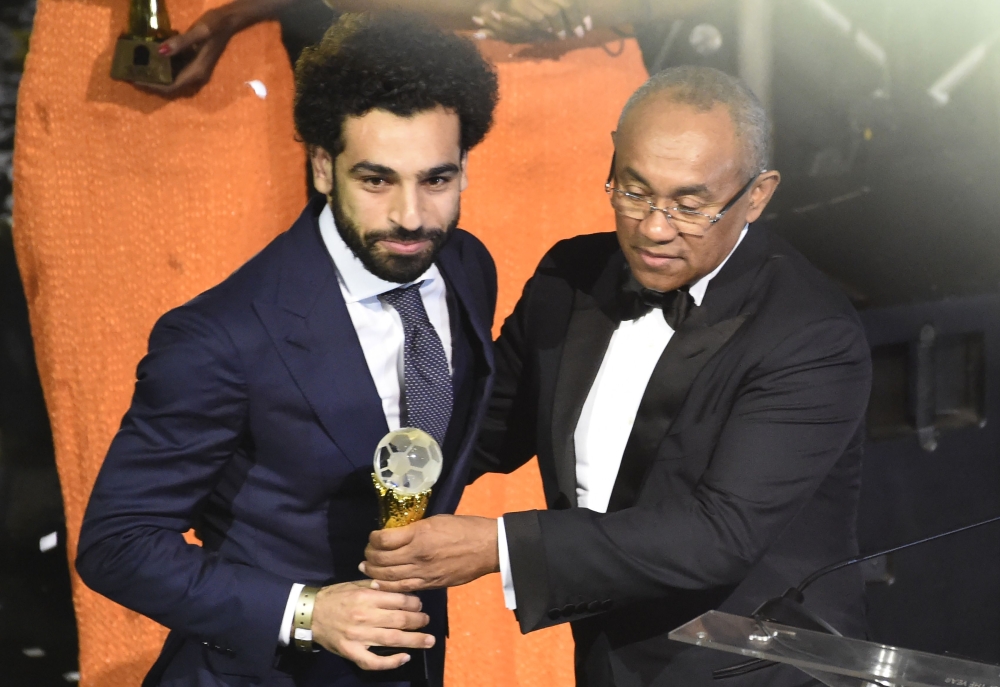 Confederation of African Football (CAF) President Ahmad Ahmad (R) presents The African Footballer of the Year Award to Egypt and Liverpool striker Mohamed Salah during an award ceremony at the International Conference Center in Accra on Thursday. — AFP