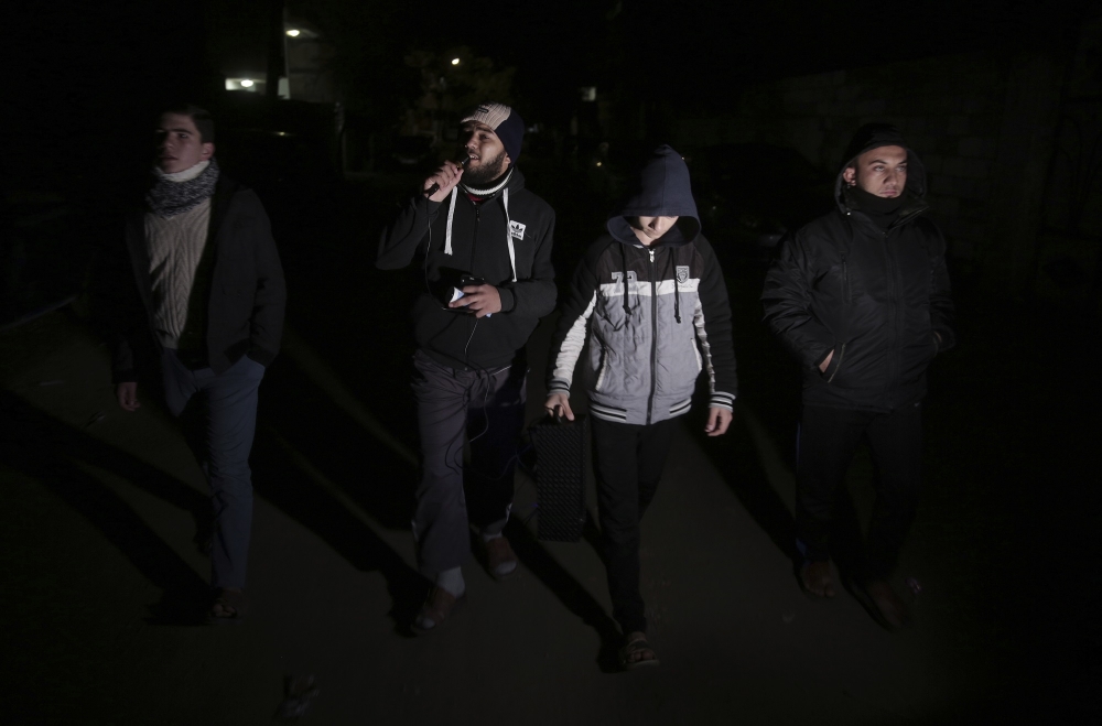 Palestinian volunteers walk use load speakers to call people to wake up for the dawn prayer in Gaza City in this Jan. 3, 2018 file photo. — AP