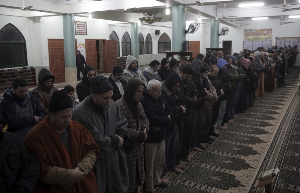 Palestinian volunteers walk use load speakers to call people to wake up for the dawn prayer in Gaza City in this Jan. 3, 2018 file photo. — AP