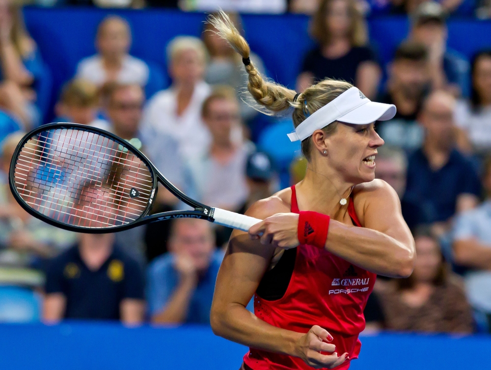 Angelique Kerber of Germany hits a return against Daria Gavrilove of Australia during their twelfth session women's singles match on day seven of the Hopman Cup tennis tournament in Perth. Australia advanced to the final. — AFP