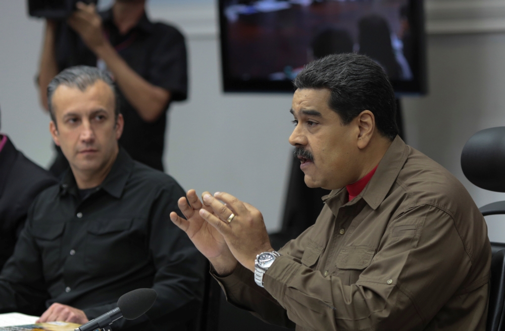 Venezuela's President Nicolas Maduro (R) speaks during a meeting with ministers in Caracas, Venezuela on Friday.  — Reuters