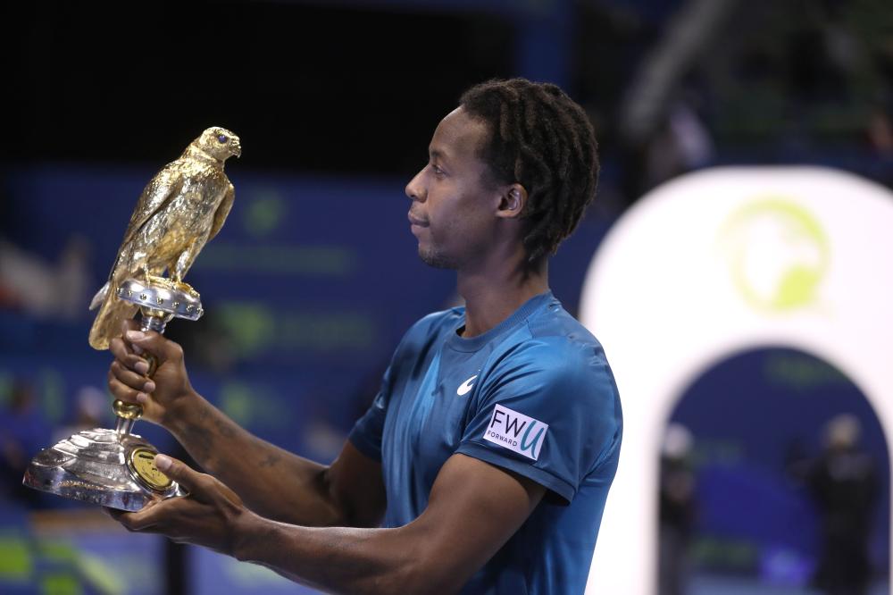 Gael Monfils of France holds the winner's trophy after beating Russia's Andrey Rublev in the ATP Qatar Open final in Doha Saturday. — AFP