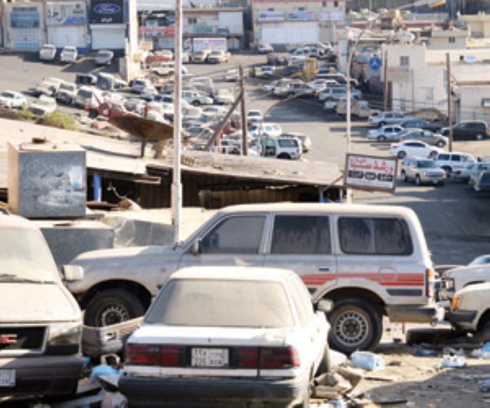 A large number of abandoned cars line the streets in the industrial area of Abha.