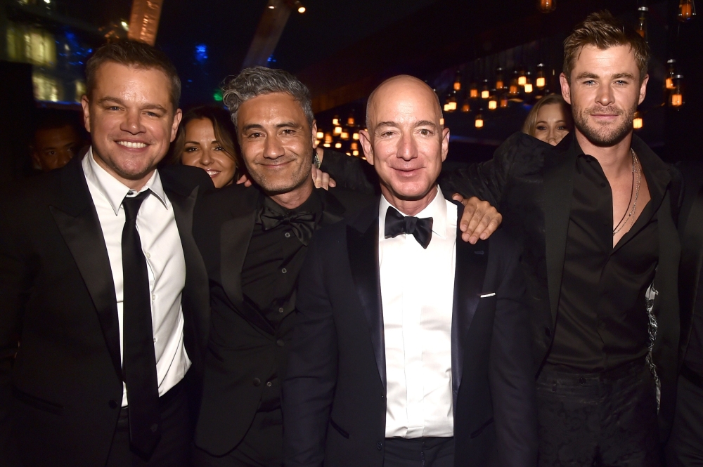 From left, Matt Damon, Taika Waititi, Amazon Founder/CEO Jeff Bezos and Chris Hemsworth attend Amazon Studios' Golden Globe Celebration in Beverly Hills, California on Monday. - AFP