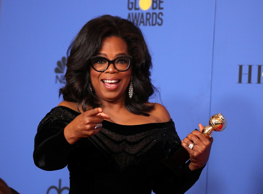 Oprah Winfrey poses backstage with her Cecil B. DeMille Award during the 75th Golden Globe Awards in Beverly Hills, California. - Reuters