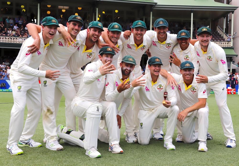 
Australia’s captain Steve Smith holds a replica Ashes urn with teammates after they won the fifth Ashes cricket Test match at SCG, Sydeny, Monday. — Reuters 