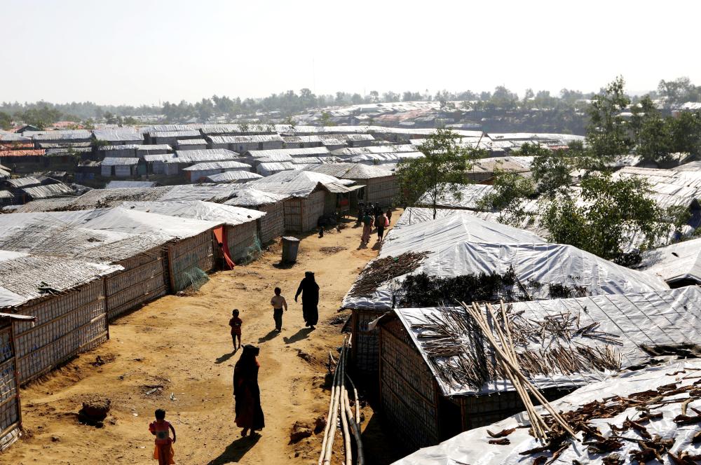 Rohingya refugees walk inside Kutupalong refugee camp near Cox’s Bazar, Bangladesh, on Monday. — Reuterss