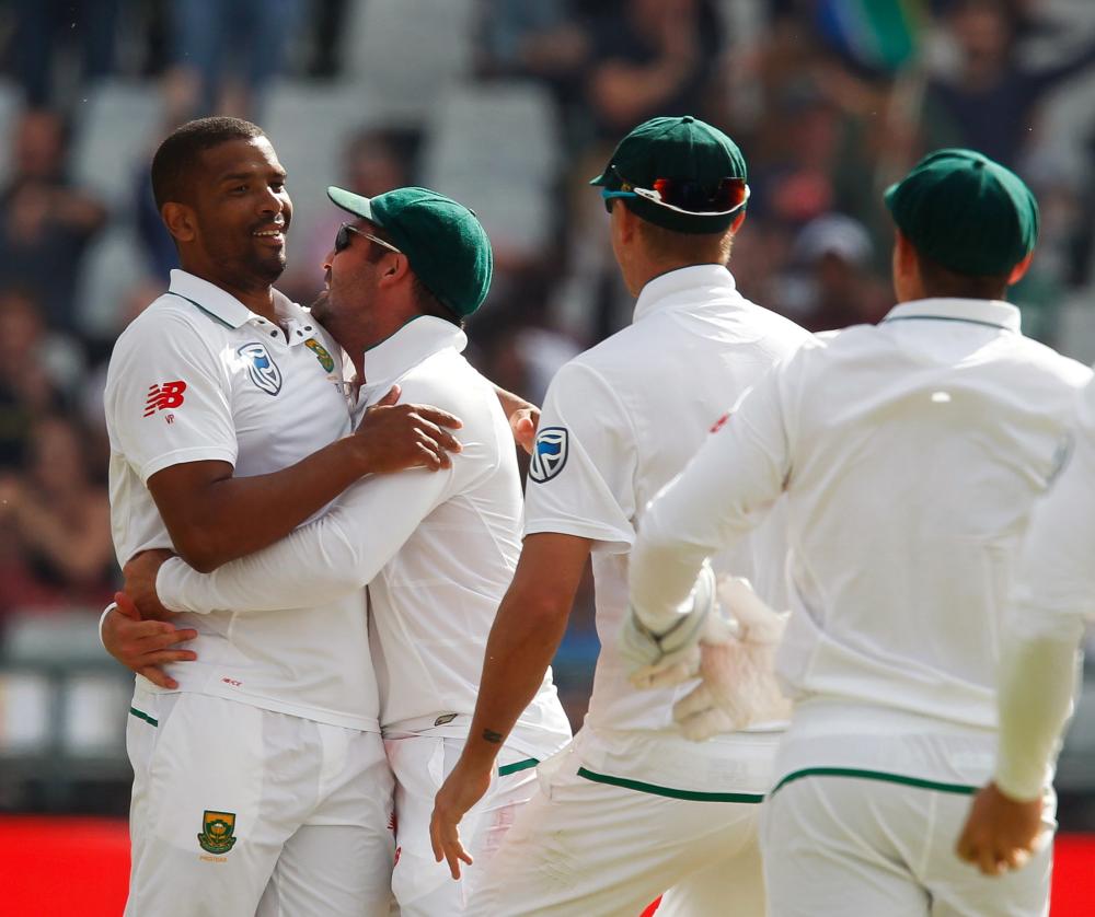 South Africa’s bowler Vernon Philander (L) celebrates with teammates after bowling out India on the fourth day of the first Cricket Test at Newlands Stadium in Cape Town Monday. — Reuters