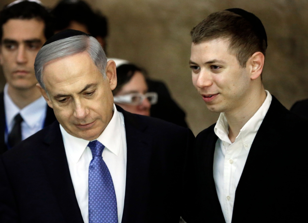 This file photo shows Israeli Prime Minister Benjamin Netanyahu (L) with his son Yair . — AFP