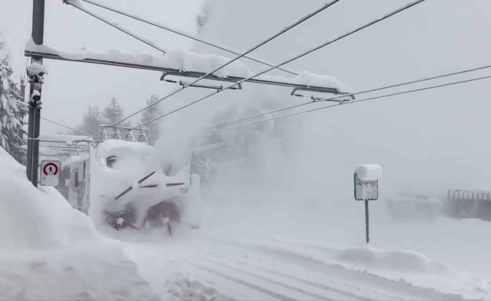 A train clears snow from a railway in Zermatt resort, Switzerland, on Monday. — Reuters