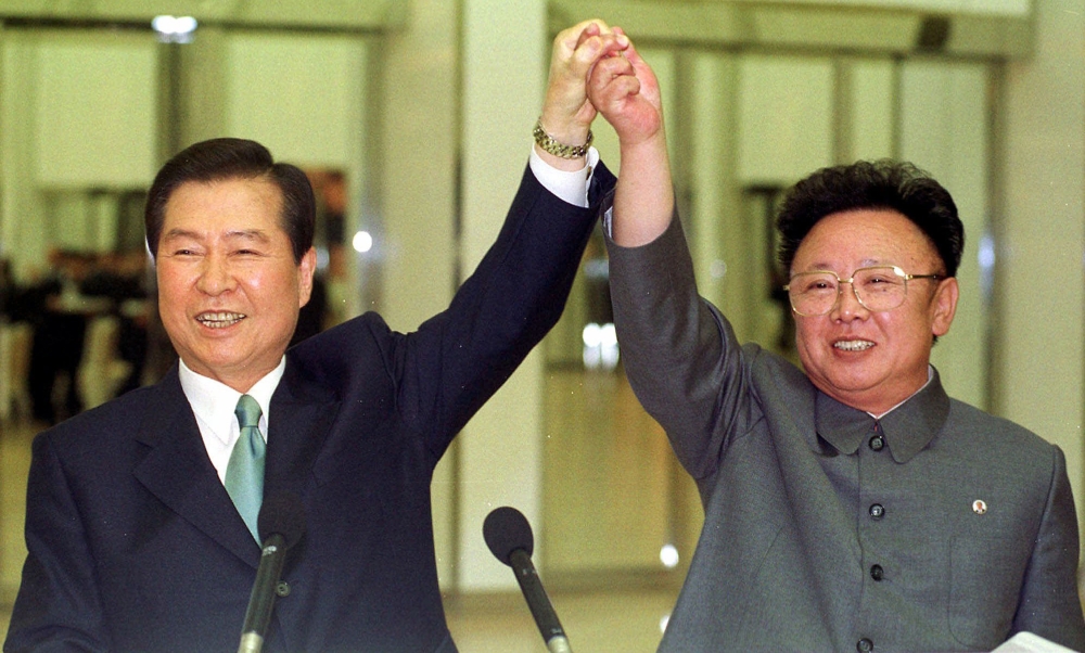 South Korean President Kim Dae-jung, left, and North Korean leader Kim Jong Il raise their arms together before signing a joint declaration during a summit in Pyongyang, North Korea, in this June 14, 2000 file photo. — AP