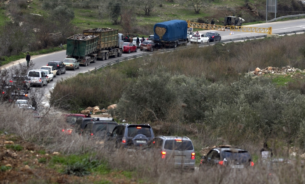 Israeli forces close a road in the area where a 35-year-old Israeli rabbi was killed late on Tuesday while driving near the wildcat settlement where he lived, around the West Bank village of Jit near Nablus. — AFP