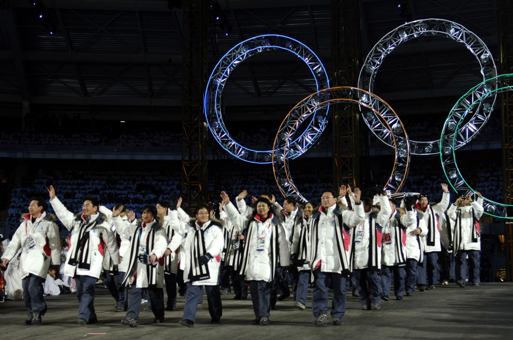 This file photo shows South Korean and North Korean athletes marching together during the opening ceremony of the 2006 Winter Olympics at the Olympic stadium in Turin. South Korea has proposed marching together with North Korea at next month's Winter Olympics opening ceremony and also forming a joint women's ice hockey team. — AFP