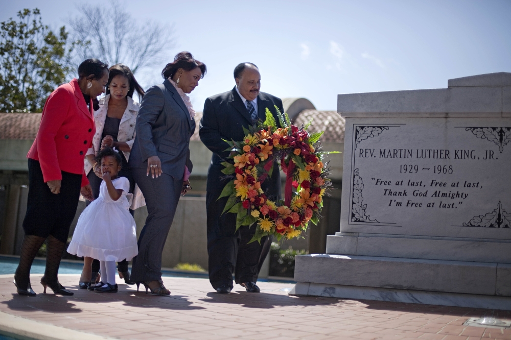 In this file photo, Martin Luther King III, right, the son of Rev. Martin Luther King Jr., lays a wreath at the crypt of his father along with from right, Rev. King's daughter, Rev. Bernice King, granddaughter Yolanda, 2, her mother Arndrea King, and Christine King Farris, sister of Dr. King Jr., on the 43rd anniversary of his assassination in Atlanta. — AP