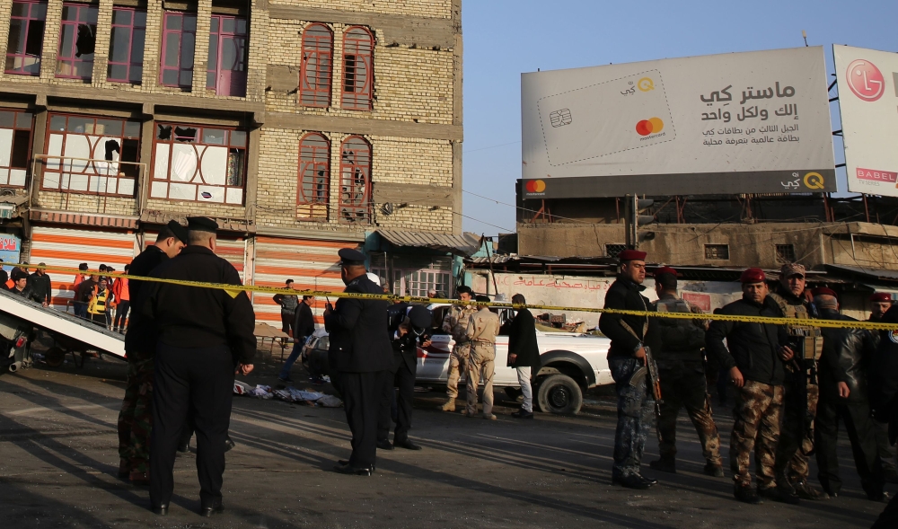 Iraqi security forces cordon off the area where a double suicide bombing killed at least 38 people in central Baghdad on Monday, the second such attack in the Iraqi capital in three days. — AFP