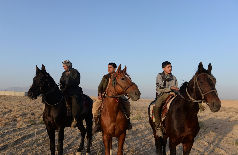 This photo taken on Nov. 8, 2017, shows Afghan men riding horses in Mazar-i-Sharif. The rugged men of northern Afghanistan raise their buzkashi horses to be warrior princes, ready for the savagery of polo with a headless carcass. - AFP