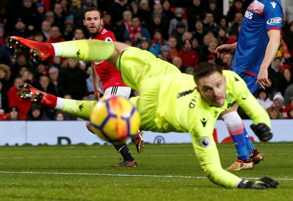 Manchester United’s Juan Mata shoots wide against Stoke City during their Premier League match at Old Trafford Monday. — Reuters