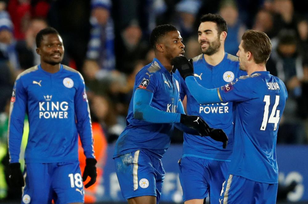 Leicester City’s players congratulate Kelechi Iheanacho for his goal after a VAR against Fleetwood Town at King Power Stadium, Leicester, Tuesday. — Reuters
