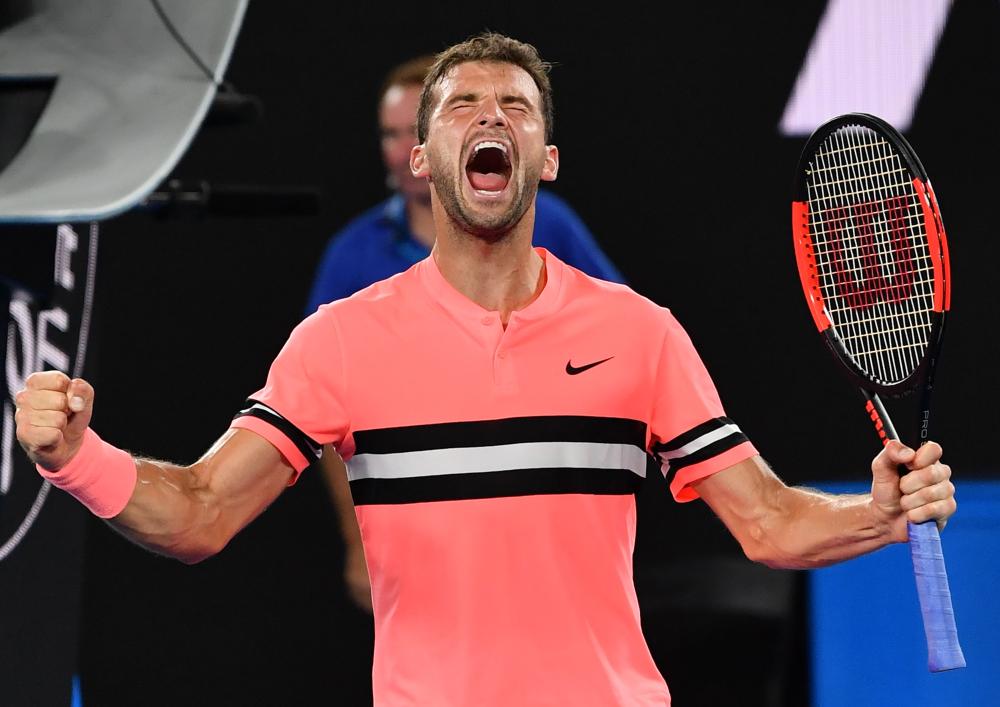 Bulgaria’s Grigor Dimitrov shouts after beating Mackenzie McDonald of the US at the Australian Open Wednesday. — AFP