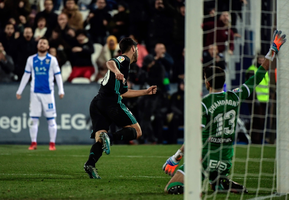 Real Madrid's Spanish midfielder Marco Asensio celebrates after scoring a goal during the Spanish 'Copa del Rey' (King's Cup) football match against Leganes at the Estadio Municipal Butarque in Leganes on Thursday. — AFP