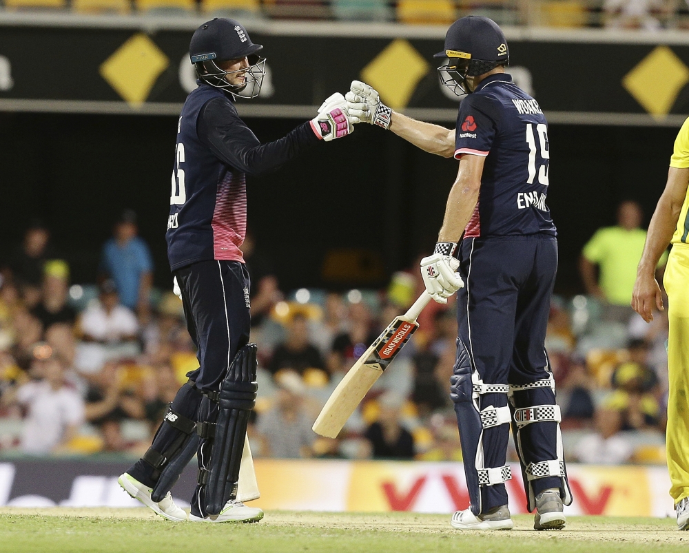 England's Joe Root, left, and Chris Woakes, right, celebrate after winning the match during the one day cricket match between against Australia in Brisbane, Friday. — AP