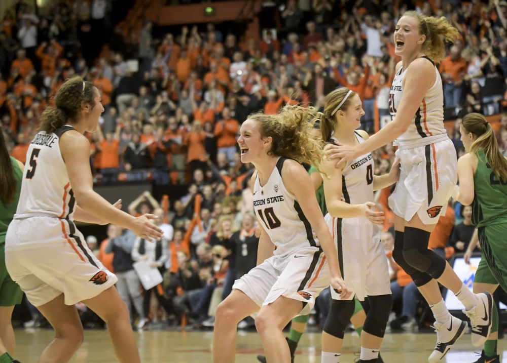 No. 18 Oregon State women celebrating their victory over No. 7 Oregon Friday. — AP