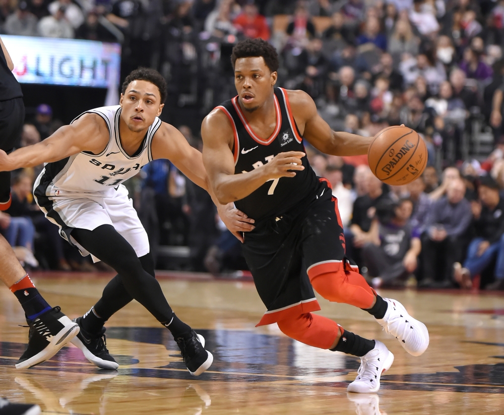 Toronto Raptors’ guard Kyle Lowry (R) gets past San Antonio Spurs’ guard Bryn Forbes during their NBA game at Air Canada Centre in Toronto Friday. — Reuters
